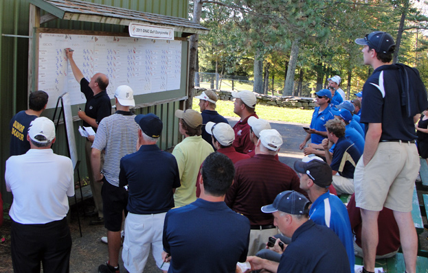 Players and coaches watch as the GNAC Championship leaderboard is entered by GCC Pro Rick Altham